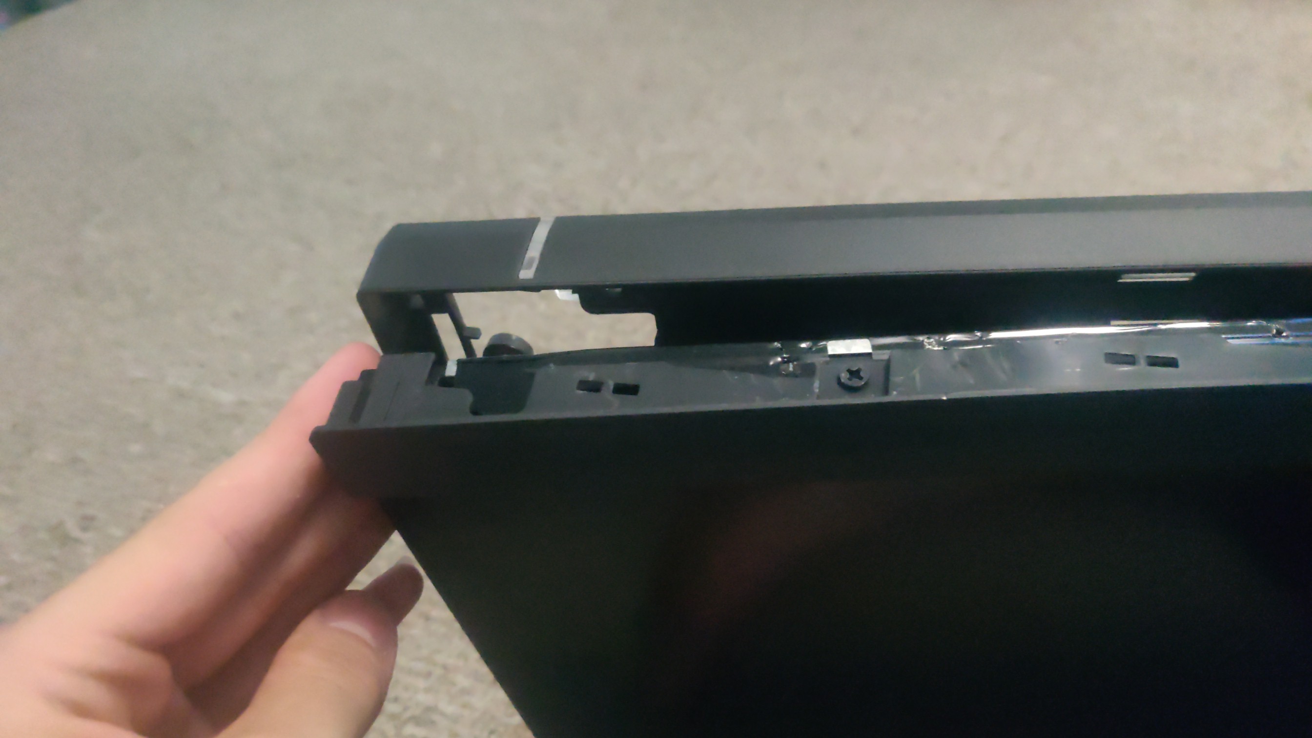 Monitor showing plastic bezel being removed